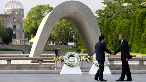 US President Barack Obama, right, shakes hands with Japanese Prime Minister Shinzo Abe at Hiroshima Peace Memorial Park in Hiroshima, western Japan, as Obama became the first sitting U.S. president to visit the site of the world's first atomic bomb attack.