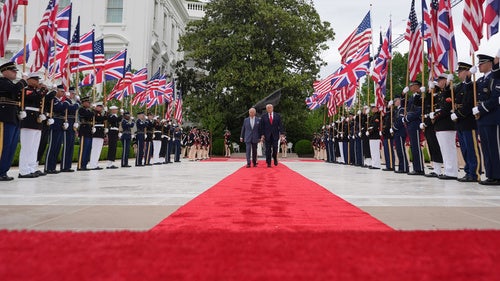 President Donald Trump walks on the red carpet in the Rose Garden with Britain's King Charles III