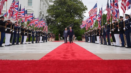 President Donald Trump walks on the red carpet in the Rose Garden with Britain's King Charles III