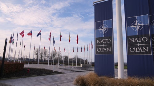 Flags flap in the wind outside NATO headquarters in Brussels