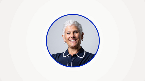 A headshot of Deborah Rosenblum surrounded by a blue ring and a beige background.