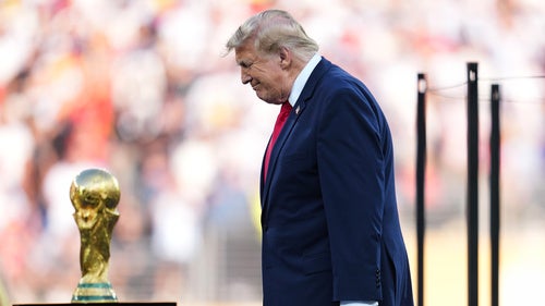 President DonaldTrump walks onto the stage for the trophy presentation during the World Cup final