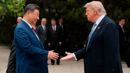 US President Donald Trump shakes hands with Chinese President Xi Jinping.
