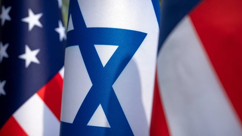 US and Israel flags stand outside of the White House