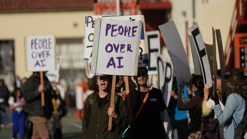 Protesters demonstrate outside of the OpenAI DevDay 2026 conference