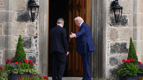 U.S. President Donald Trump, right, and British Prime Minister Keir Starmer walk at Trump International Golf Links in Aberdeenshire, Scotland, Monday, July 28, 2025. 