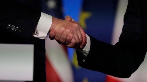 Two people shake hands