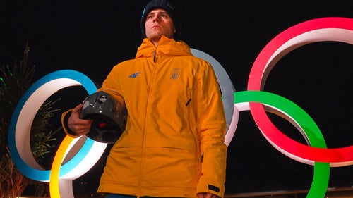 Ukraine's Vladyslav Heraskevych holds up his crash helmet during a press conference following a skeleton training session at the 2026 Winter Olympics, in Cortina d'Ampezzo, Italy, Tuesday, Feb. 10, 2026.
