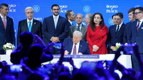  President Donald Trump signs the charter of his Board of Peace initiative at the Annual Meeting of the World Economic Forum in Davos, Switzerland, Jan. 22, 2026. 
