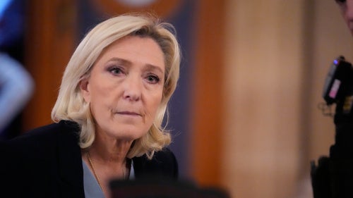 Far-right leader Marine Le Pen walks outside the courtroom during a short break in her appeals trial in Paris, on Jan. 20, 2026.