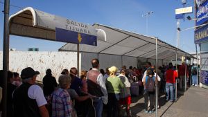 People wait in line at the US-Mexico border.