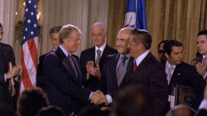Carter and Omar Torrijos shake hands moments after the signing of the Torrijos-Carter Treaties.