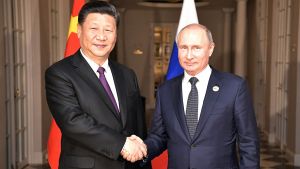 Vladimir Putin and Xi Jinping shaking hands on July 26, 2018.