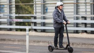 Man riding an e-scooter. 