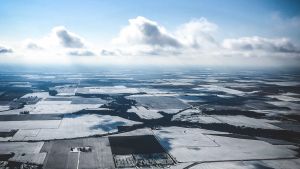 Aerial view of fields in Iowa during winter, covered in snow.
