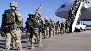 Members of the 82nd Airborne board a plane to deploy to Kuwait