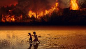 Children play in lake next to raging fire in the Amazon Rainforest.