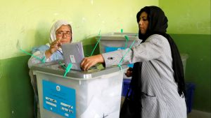 An Afghan woman casts her vote during parliamentary elections at a polling station in Kabul, Afghanistan