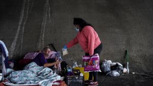 Dominick Walton, who is homeless herself, serves food to homeless people amid the coronavirus disease (COVID-19) outbreak in Houston, Texas, U.S