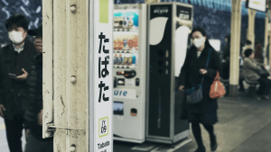 People wearing medical face masks at a train station in Japan