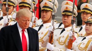 President Trump walks past Chinese military display.