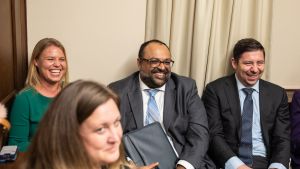 A group of Emerging Leaders laughing at a roundtable event. 