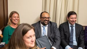 A group of Emerging Leaders laughing at a roundtable event.