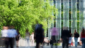 People walking in blurred motion through the Financial District of Paris, France