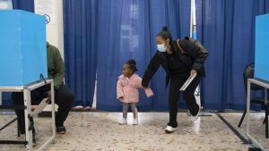A woman and her granddaughter visit an early voting site at the Dr. Martin Luther King Community Service Center in Chicago on Nov. 1, 2020