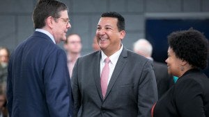 Two corporate partner members talk with Brian Hanson during a Council event
