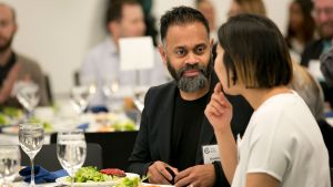 Two people talk during a Council dinner event