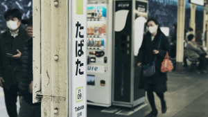 People wearing medical face masks at a train station in Japan