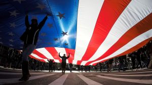 People carry the American Flag during a Veteran's Day parade