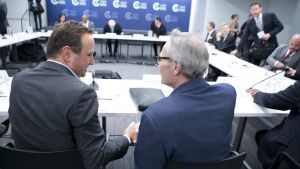 Two people shake hands during a roundtable event at the Council