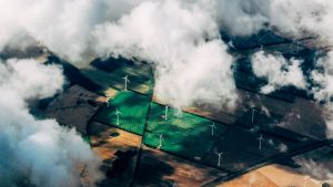 Aerial shot of Midwest fields with windmils