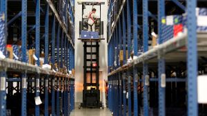 A UPS employee uses a lift to access supplies in a storage facility