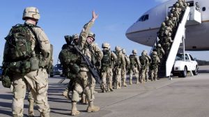 American troops board plane