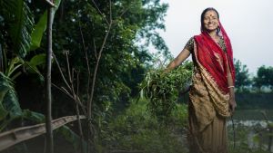 A woman holds greens. 