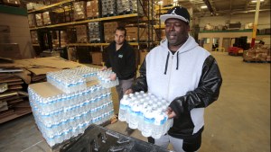 Man picks up bottled water from the Food Bank of Eastern Michigan to deliver to a school after elevated lead levels were found in the city's water in Flint