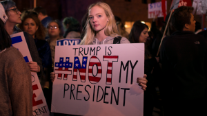 13 November 2016 Minneapolis Trump Protest, a young woman holds a sign saying "Trump is Not My President"