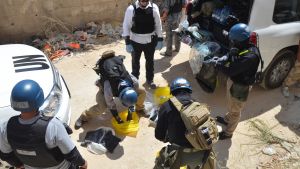 U.N. chemical weapons experts prepare before collecting samples from one of the sites of an alleged chemical weapons attack in Zamalka