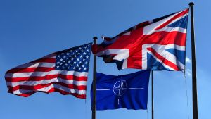 US, NATO and Britain flags fly at the Alliance headquarters in Brussels.