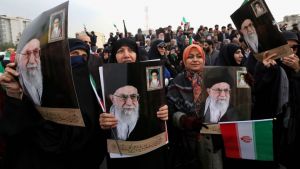 Iranian women holding national flags and pictures of Iran’s supreme leader, Ayatollah Ali Khamenei, take part a pro-government demonstration in Tehran on Nov. 25, 2019.