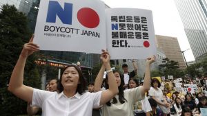 South Korean protesters hold up cards calling for a boycott of Japanese products during a rally 
