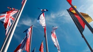 National flags on flagpoles against a blue sky
