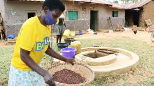 A woman prepares to store beans using SAWBO techniques.