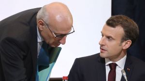 French President Emmanuel Macron speaks with presidential diplomatic advisor Philippe Etienne.