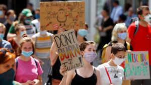 People hold banners during a protest march to call for action against climate change in Vienna, Austria.