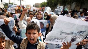 Boys demonstrate outside the offices of the United Nations in Sanaa, Yemen to denounce last weeks air strike that killed dozens including children in the northwestern province of Saada