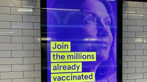 An NHS ad in a UK subway appeals commuters to get vaccinated.